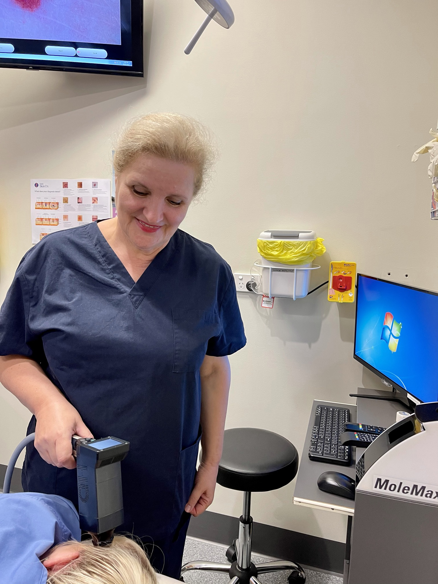 Dr Djendjinovic checking a patient's mole